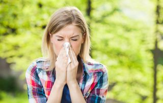girl outside blowing nose after results from allergy testing