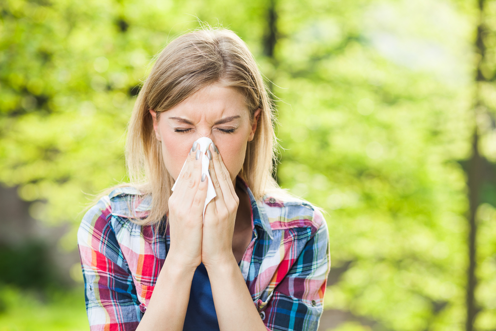 girl outside blowing nose after results from allergy testing