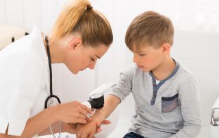 best pediatric allergist near me treating young boy in office
