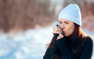 woman using inhaler outside during winter due to las vegas allergies