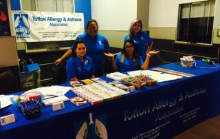 las vegas allergy doctor and nurses at table at health fair